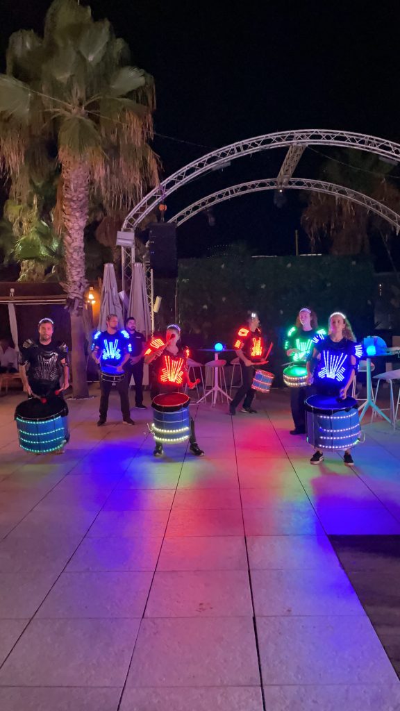 LED drummers Barcelona performing at a corporate event in Go Beach.