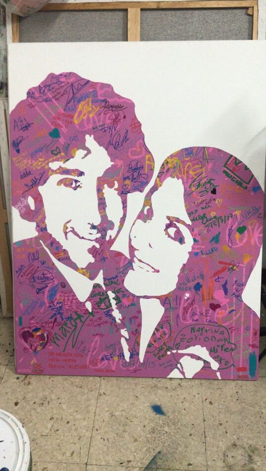 Live artist painting a revealing canvas for luxury wedding entertainment.