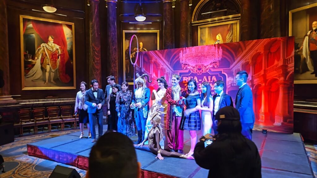 Professional themed entertainment performers in elaborate period costumes providing interactive entertainment and roaming performances at a luxury event